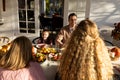 Image of multi generation caucasian family eating outdoor dinner Royalty Free Stock Photo