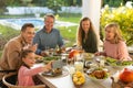 Image of multi generation caucasian family eating outdoor dinner Royalty Free Stock Photo