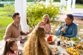 Image of multi generation caucasian family eating outdoor dinner Royalty Free Stock Photo