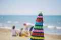 Image of a multicolor sun umbrella closed with people