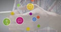 Image of multiple digital icons against mid section of man using smartphone