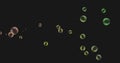 Image of multiple green and yellow bubbles floating across black background Royalty Free Stock Photo