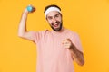 Image of muscular athletic young man having fun and lifting dumbbell Royalty Free Stock Photo