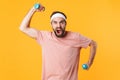 Image of muscular athletic young man having fun and lifting dumbbells Royalty Free Stock Photo