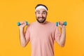 Image of muscular athletic young man having fun and lifting dumbbells Royalty Free Stock Photo