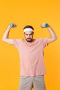 Image of muscular athletic young man having fun and lifting dumbbells Royalty Free Stock Photo