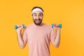 Image of muscular athletic young man having fun and lifting dumbbells Royalty Free Stock Photo