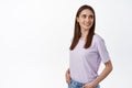 Image of natural young woman with candid smile, turn head and look behind shoulder at promo text, staring at banner with Royalty Free Stock Photo