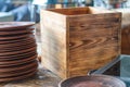 Image of neatly stacked wooden plates with a light brown color and visible grain patterns, placed on a wooden table in a Royalty Free Stock Photo
