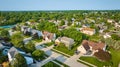 Neighborhood with amenities middleclass houses in summer with tennis court aerial