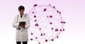 Image of network of connection with interface medical icons and a Caucasian male doctor using a tabl Royalty Free Stock Photo
