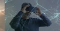 Image of networks of connections and digital human brain over man wearing vr headset Royalty Free Stock Photo