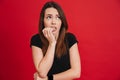 Image of neurotic woman 20s in black t-shirt biting nails and fe