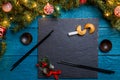 Image of New Year branches of fir, black board, sticks for sushi, cookies with prediction Royalty Free Stock Photo