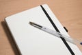 Image of a notebook on which there is a pen used to make notes with copy space Royalty Free Stock Photo