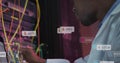 Image of notification bars, african american engineer checking data server system using laptop Royalty Free Stock Photo