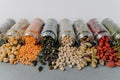 Image of nutrient pinenuts, mung beans, sunflower seeds, chickpea, pistachio spilled from glass containers. Healthy nutrition