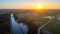 Golden Sunrise Over Rural Canal and Farmland Royalty Free Stock Photo