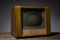 Image of an old brown wooden television, side view isolated on grey background.