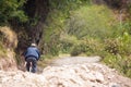 Image of an old man biking in rural part of Urubamba Peru