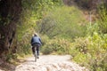 Image of an old man biking in rural part of Urubamba Peru