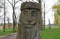 The image of an old man, forest goblin. Wooden sculptures of fabulous people in the park. Original author`s woodwork Royalty Free Stock Photo
