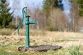 Old manual water pump. Vintage cast iron water pump with handle for pumping.