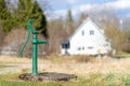 Old manual water pump. Vintage cast iron water pump with handle for pumping.