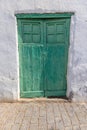 Image of an old Mediterranean green wooden door in a historic village Royalty Free Stock Photo