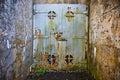 Old mine entrance with cement walls and huge steel door rusting Royalty Free Stock Photo