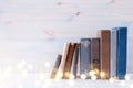 Image of old vintage books on a wooden shelf. Glitter overlay Royalty Free Stock Photo
