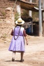 Image of a old woman walking in a Andean town in Urubamba Peru