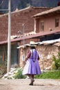 Image of a old woman walking in a Andean town in Urubamba Peru