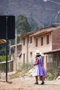 Image of a old woman walking in a Andean town in Urubamba Peru