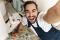 Optimistic young man plumber work in uniform Royalty Free Stock Photo