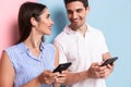 Image of optimistic man and woman wearing earphones and using sm