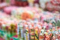 Image out of focus, tasty colorful lollipops different shapes on the counter fair