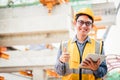 Image outside the industrial construction engineers in yellow protective helmet discuss new project while using laptop and happy