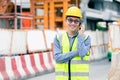 Image outside the industrial construction engineers in yellow protective helmet discuss new project while walkie talkie and happy Royalty Free Stock Photo