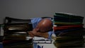 Image with Overworked Employee Sleeping on the Desk in the Office