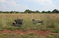 ABANDONED UPHOLSTERED CHAIRS IN A FIELD