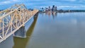 Panorama Ohio River rose gold truss bridge spanning toward illuminated Louisville skyscrapers