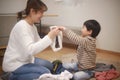 Parent and child folding laundry