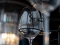 Image of a part of wine glasses hanging on a wall rack