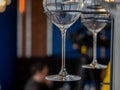 Image of a part of wine glasses hanging on a wall rack