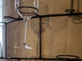 Image of a part of wine glasses hanging on a wall rack