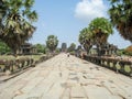Image of a path with tourists, with Asian Palmyra palms on both sides and templ Royalty Free Stock Photo