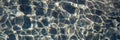 Pebble water caustics background with color refractions