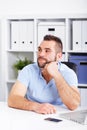 Image of pensive young businessman with notebook looking up Royalty Free Stock Photo