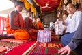Image of people in buddhist temple paying respect to monks. Religious celebration. People serving rice to monks. Royalty Free Stock Photo